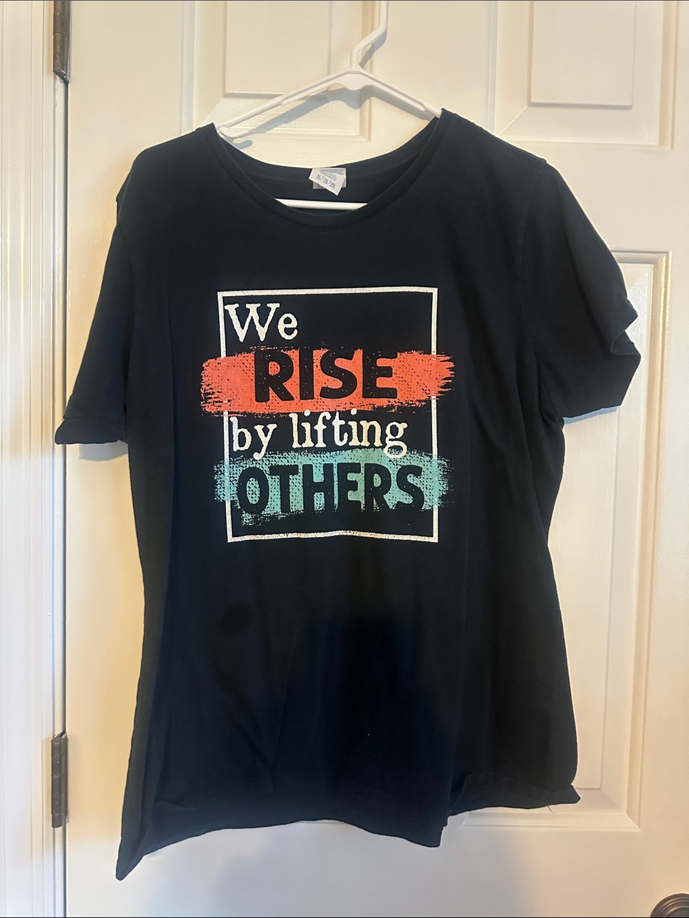 Black women’s Graphic Tee - "We Rise by Lifting Others"
